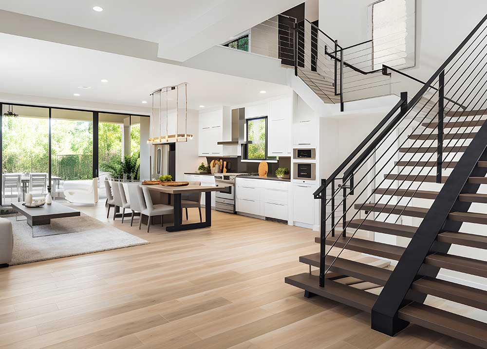 Stylish spacious kitchen and living room with refrigerator and washing machine